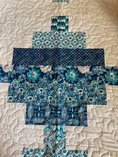 Handmade quilt with blue and turquoise stacked steps
