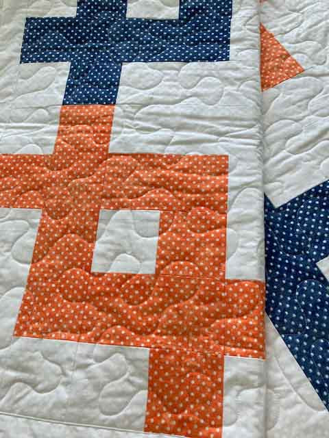 handmade quilt with unique geometric pattern with black navy turquoise green and orange