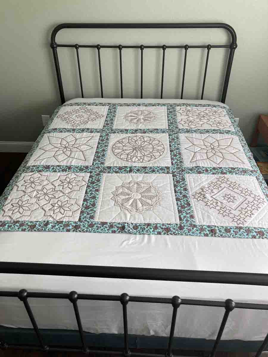 handmade quilt with embroidered blocks