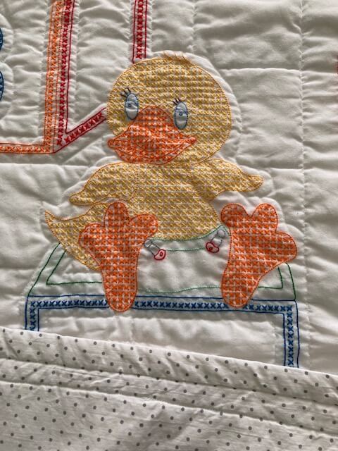 handmade embroidered alphabet crib quilt with animals