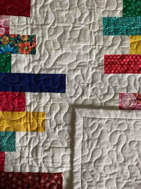 handmade quilt with colorful stacks strips of cotton fabric