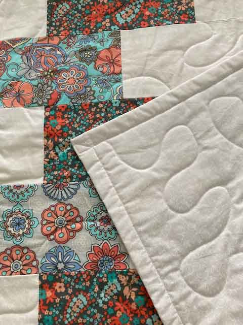 handmade quilt blue orange zipper pattern close up