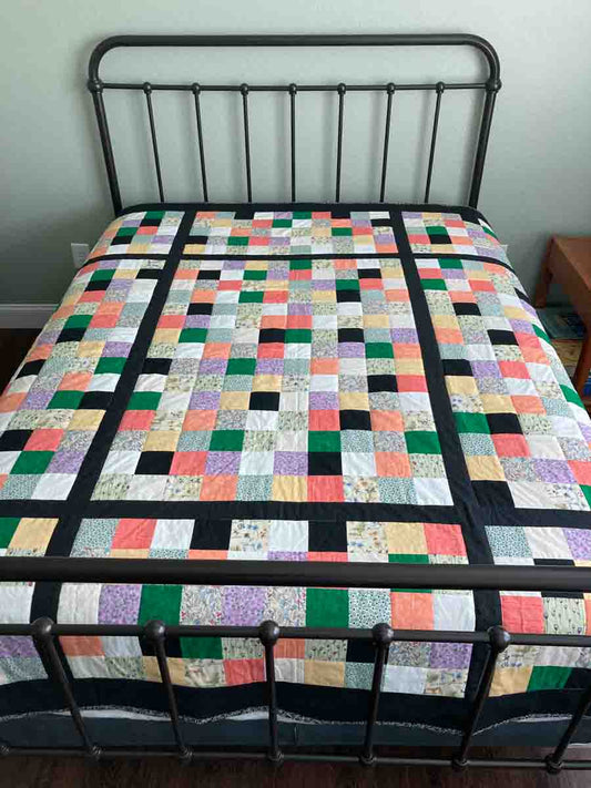 handmade quilt colorful squares pixels orange green purple black yellow