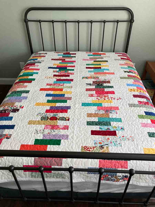 handmade quilt with colorful stacks strips of cotton fabric