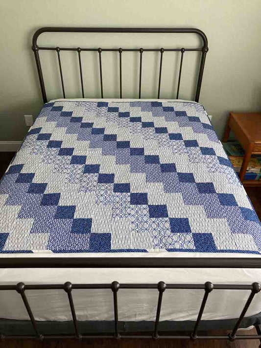 handmade quilt with diagonal blue blocks