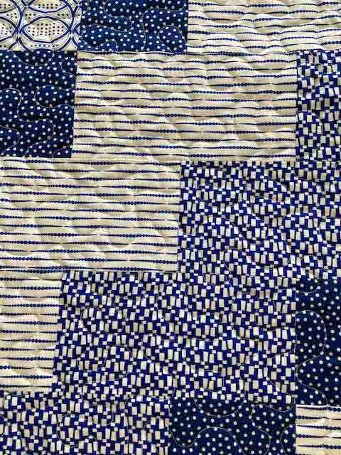 handmade quilt with diagonal blue blocks