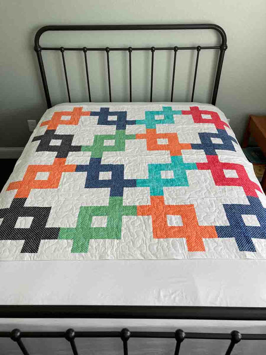 handmade quilt with unique geometric pattern with black navy turquoise green and orange